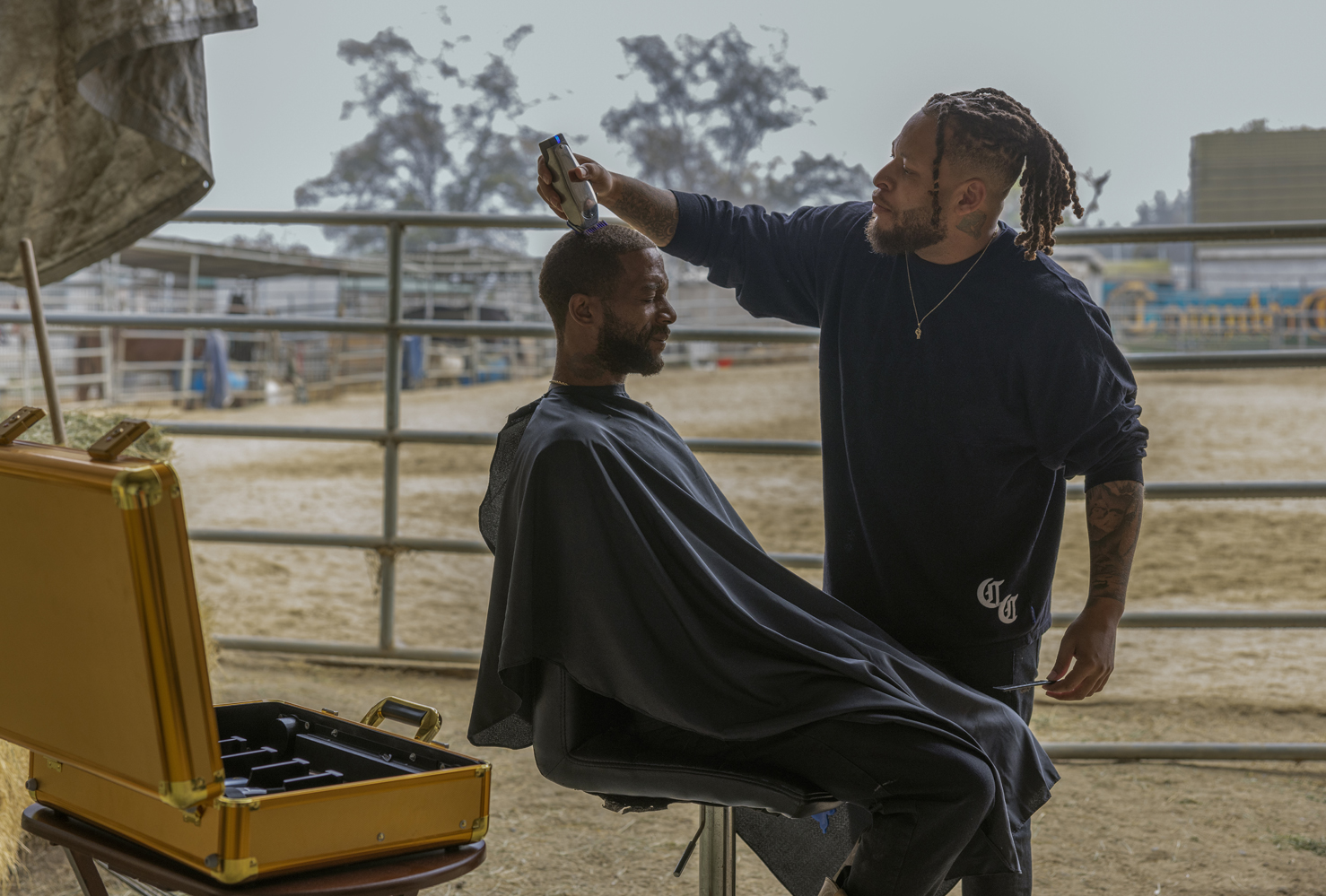 Compton Cowboys man clipping another man's hair using a Master Cordless clipper