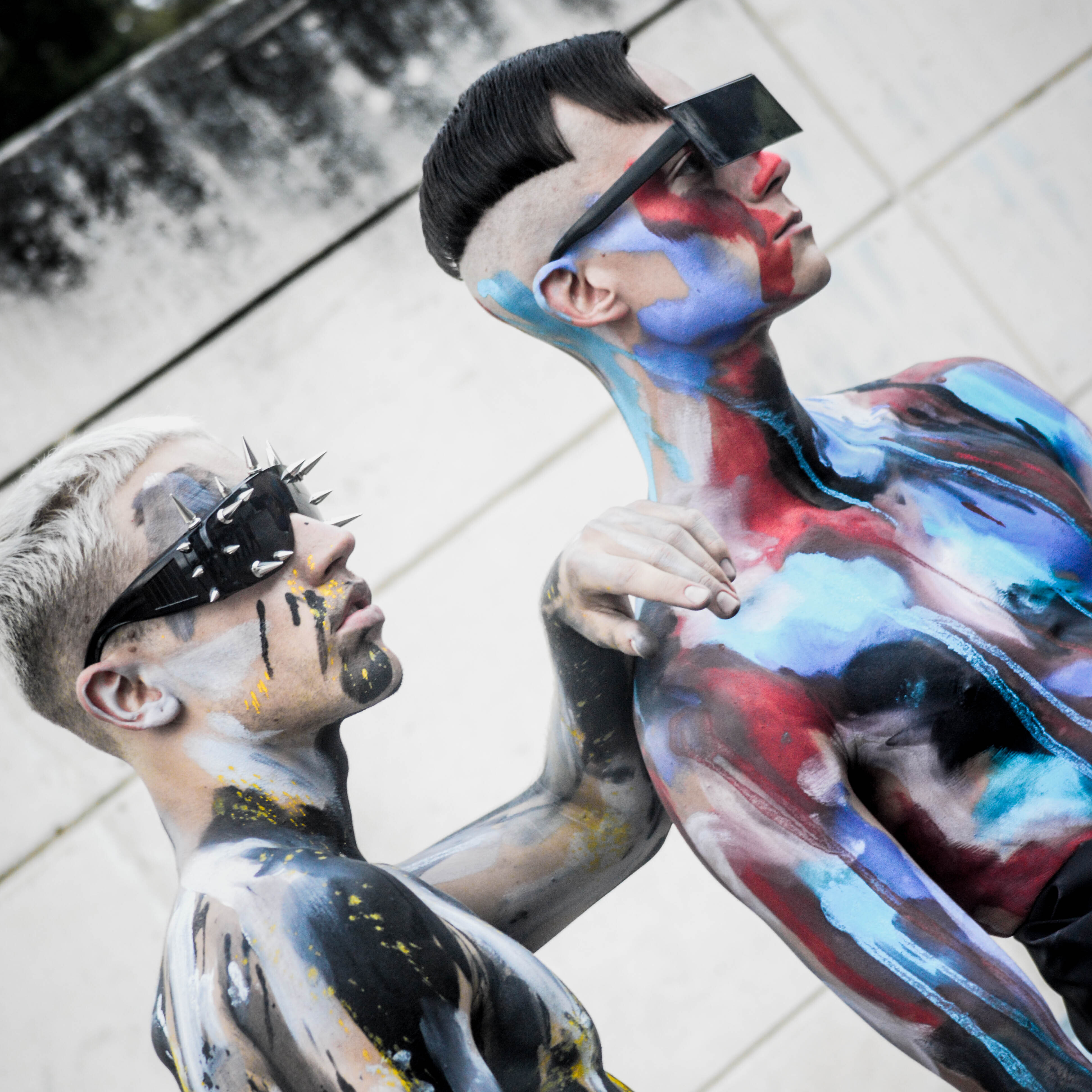 Two body painted male models with sunglasses and edgy, cool haircuts by Andis clippers.